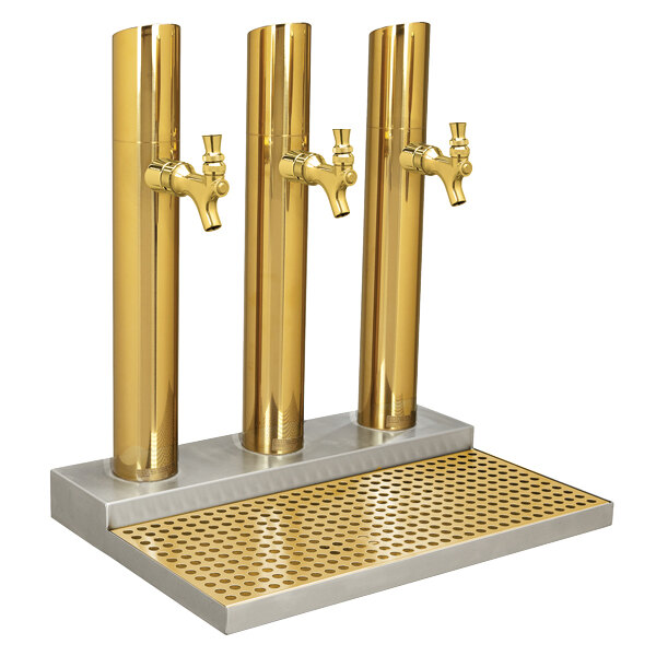 A Micro Matic brass tower with three golden pipes.