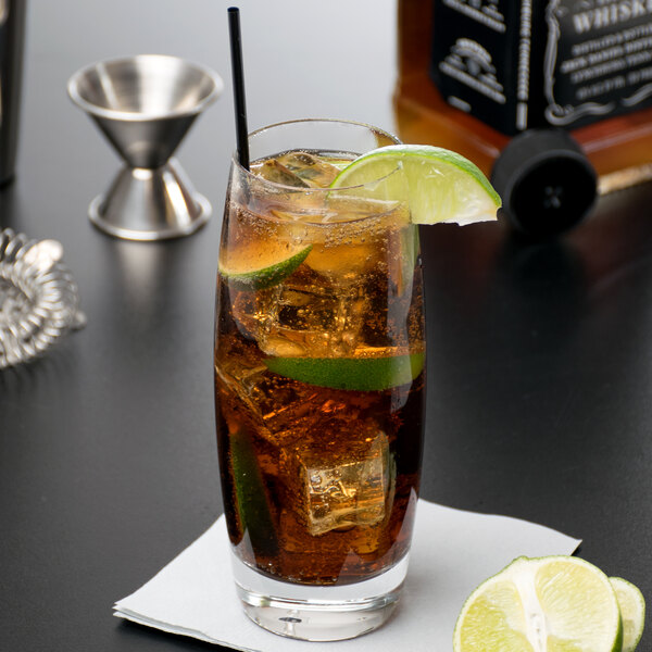 A Reserve by Libbey highball glass filled with cola, ice, and lime slices.