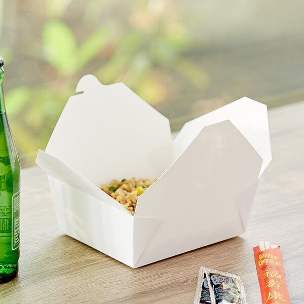 A white Choice paper take-out box with food inside.