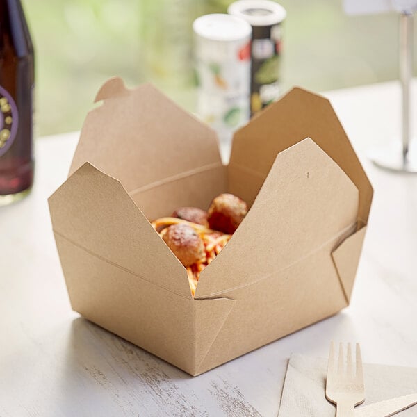 A Choice Kraft paper take-out box filled with food on a table.