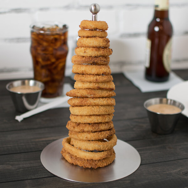 A Clipper Mill stainless steel tower of fried onion rings on a plate.