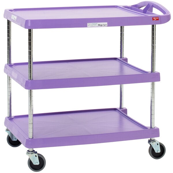 A purple Metro utility cart with three shelves and wheels.