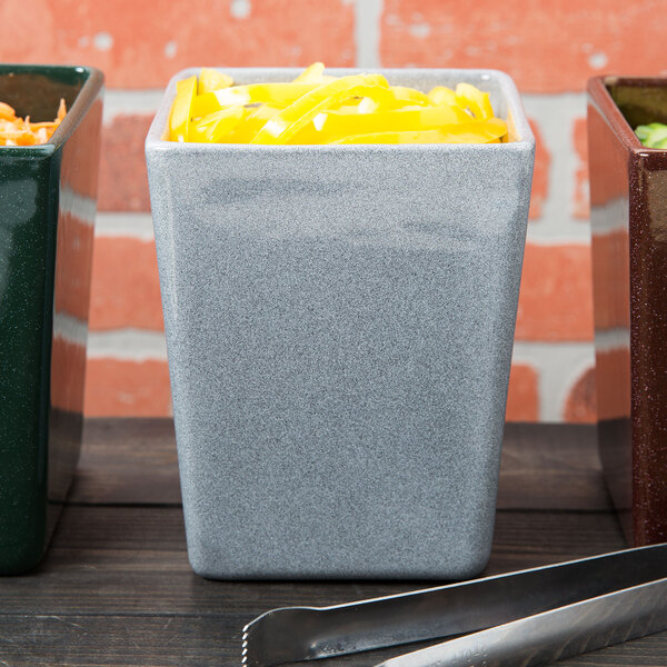 A group of Tablecraft granite salad containers with food in them.
