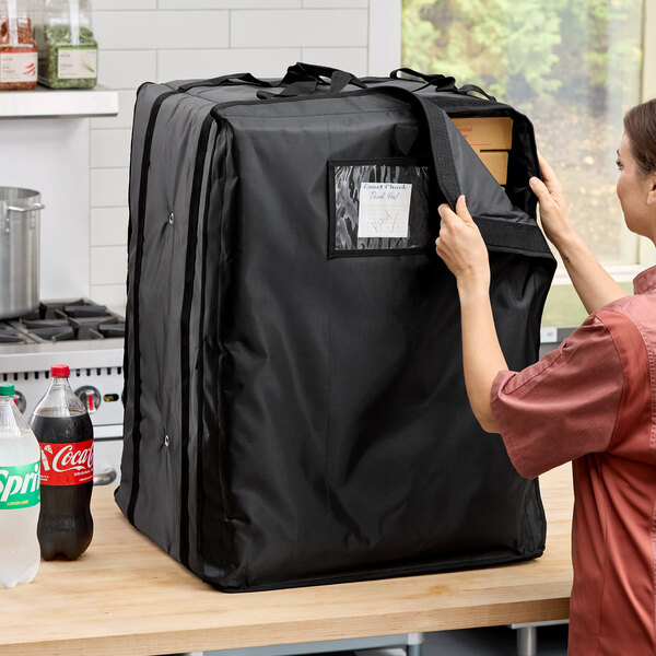 A large black insulated pizza delivery bag made of heavy-duty nylon, designed to hold up to fourteen 16-inch or 18-inch pizza boxes.