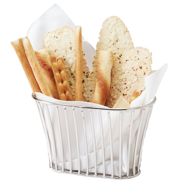 A Clipper Mill stainless steel oval basket filled with bread sticks.