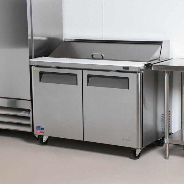 A Turbo Air stainless steel refrigerator with two doors on a counter.