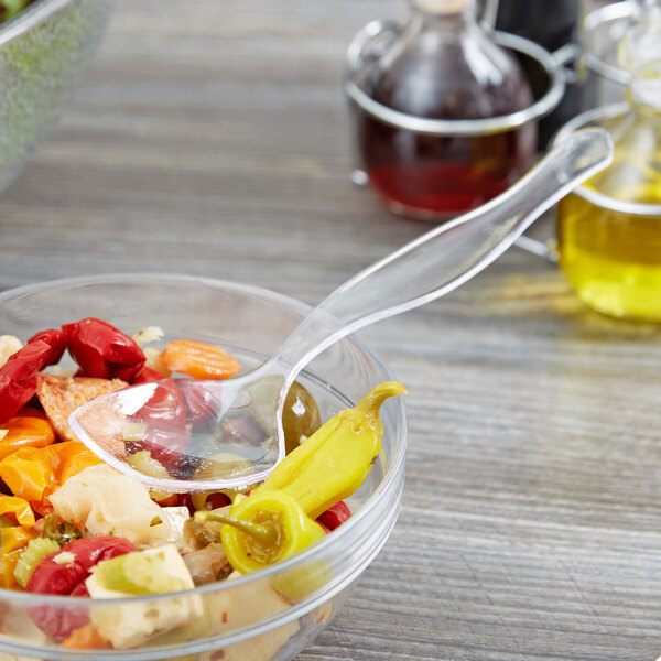 A bowl of food with a Choice clear plastic serving spoon in it.