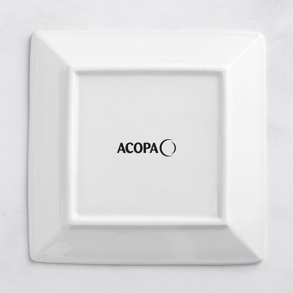 An Acopa bright white square porcelain plate with black text that reads "Acopa"