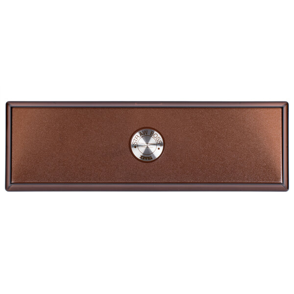 A brown rectangular lid with a round metal circle.