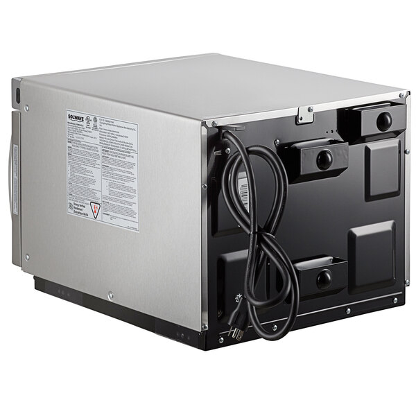 A close-up of a Solwave stainless steel commercial microwave with a black cord.