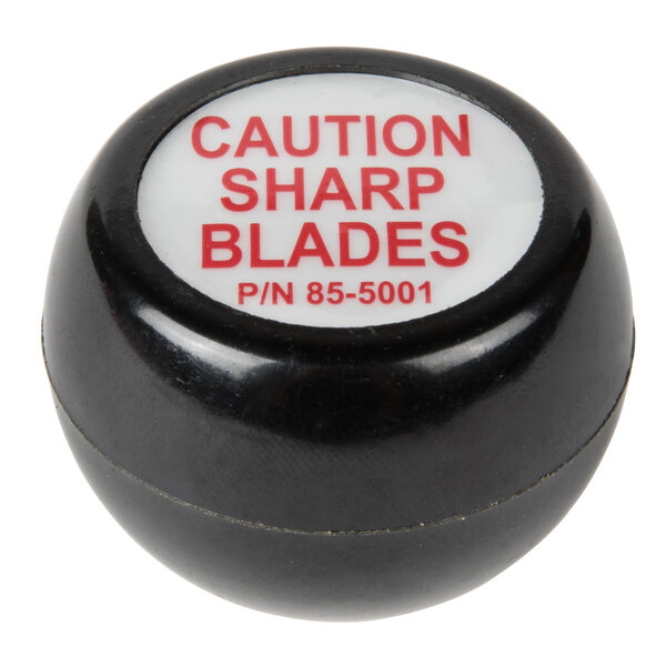 A black and white circular Vollrath knob with red text reading "Caution Sharp Blades" on it.