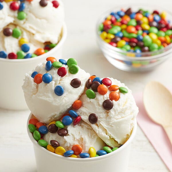 A bowl of ice cream with a scoop of Chocolate Rainbow Mini Gems on top.