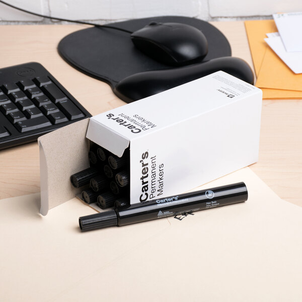 A box of Avery Carter's large black permanent markers on a desk.