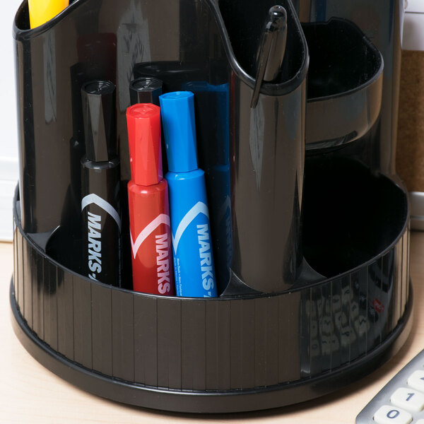 A black pen holder on a counter with Avery Marks-A-Lot permanent markers in red, blue, and black.
