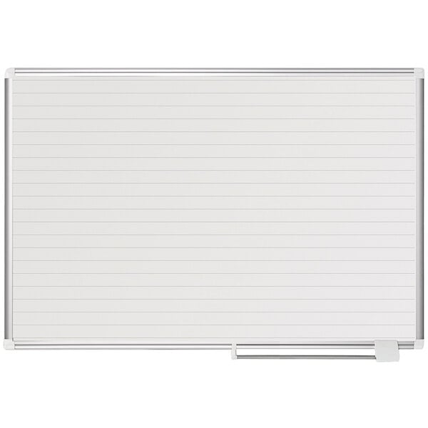 A white board with a metal frame and lined paper on it.