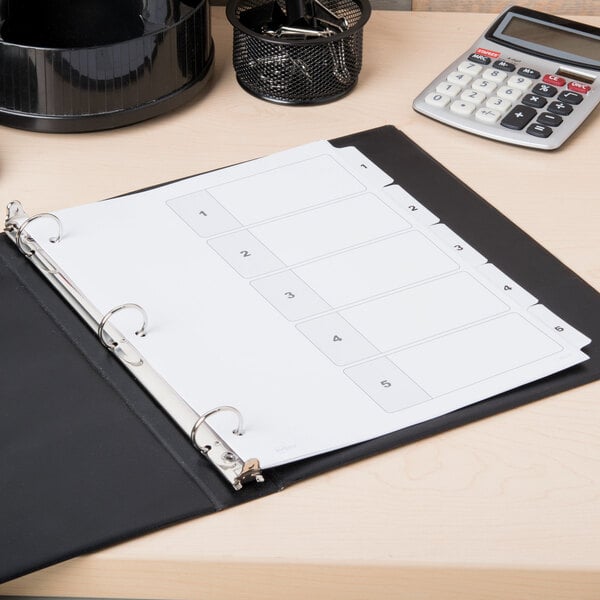 A white binder with Avery Ready Index 5-tab dividers on a table.