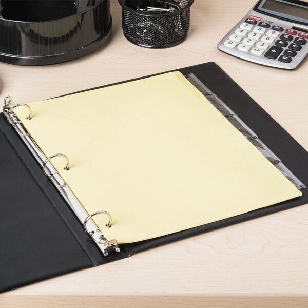 A binder with Avery Big Tab Clear Dividers with a yellow paper in it.
