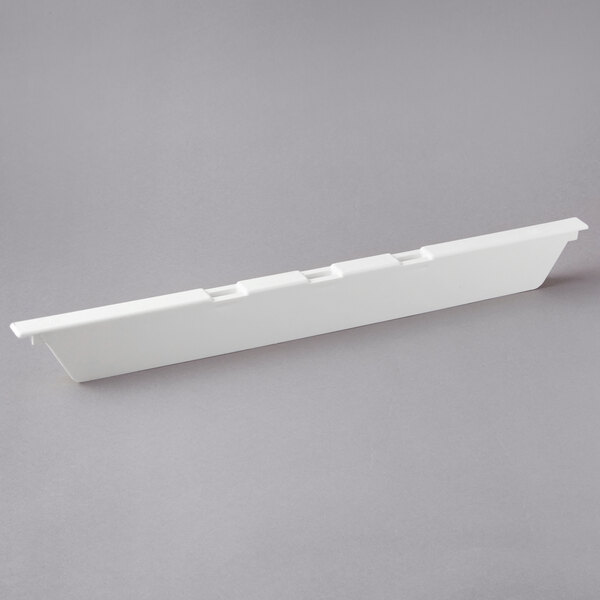 A white rectangular Cambro divider with holes.