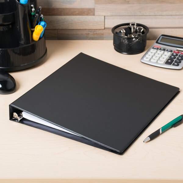 An Avery black non-view binder with slant rings on a desk.