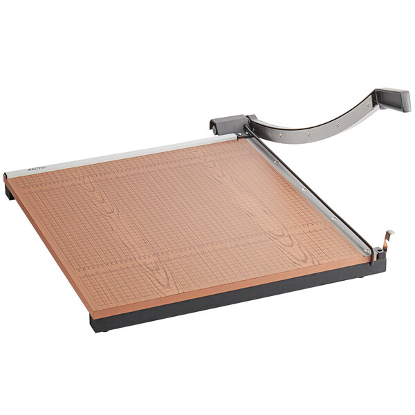 A X-Acto paper cutter with a metal handle and a wood base.