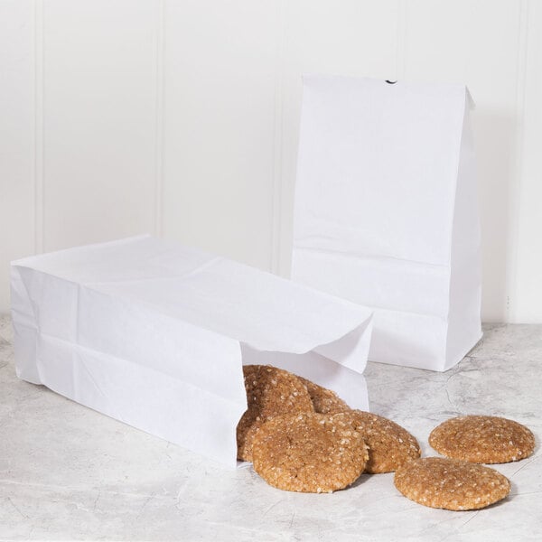 Two Duro white paper bags filled with cookies.