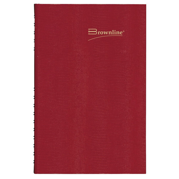A red leather Brownline 2024 Daily Planner with gold text on the cover.