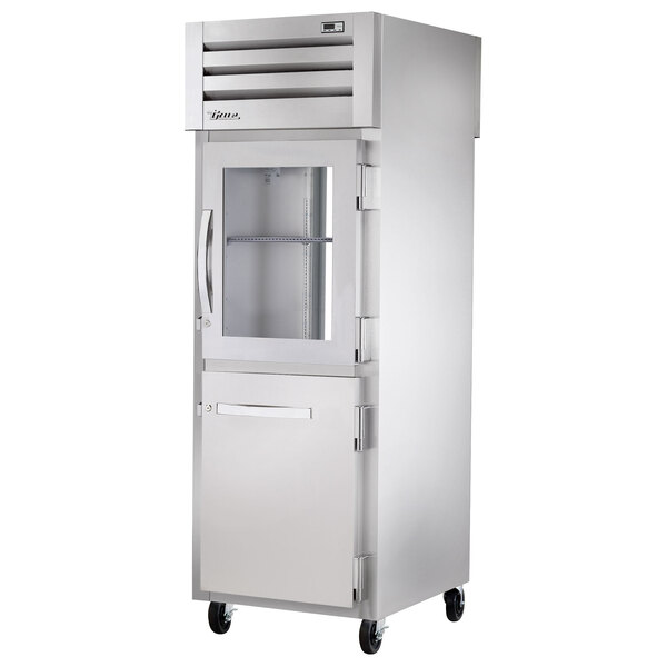 A stainless steel True pass-through refrigerator with half glass doors.