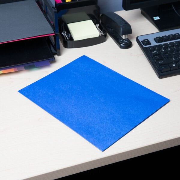 A light blue Universal 2-pocket paper folder on a desk.