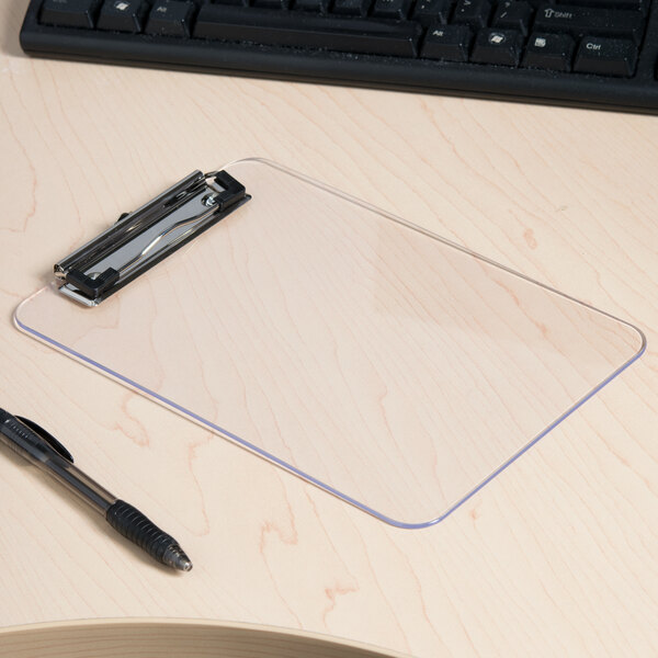 A Universal clear plastic clipboard on a desk with a pen.