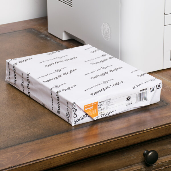 A white package of International Paper Springhill Ivory Smooth Index Cardstock on a table.