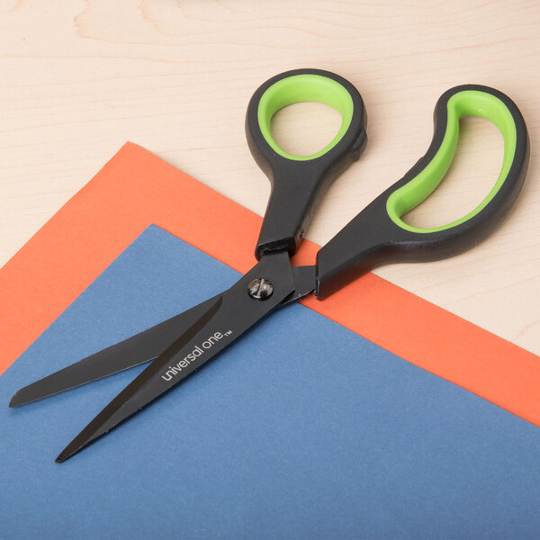 Universal 8" carbon-coated industrial scissors with black and green bent handles on a table.