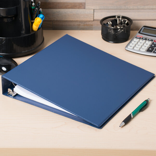 A Universal royal blue binder with non-stick cover and round rings on a desk.