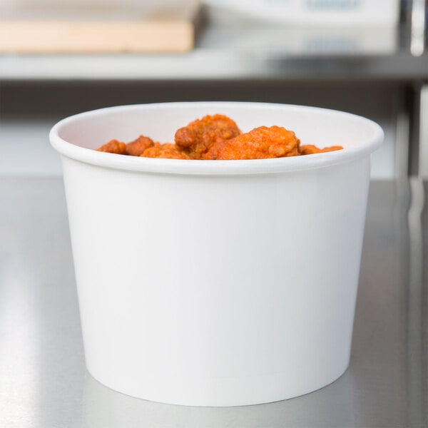A white Huhtamaki paper food container filled with food.