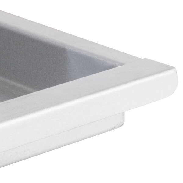 An Avantco white metal grease tray with a handle.
