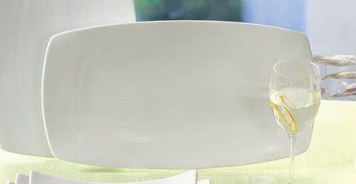 A white CAC Sushia rectangular porcelain plate with a fork on it.