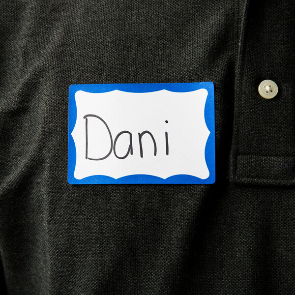 A person wearing a shirt with an Avery name tag.