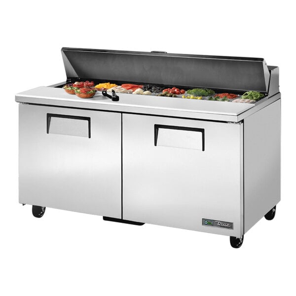 A large stainless steel True refrigerated sandwich prep table on a counter.