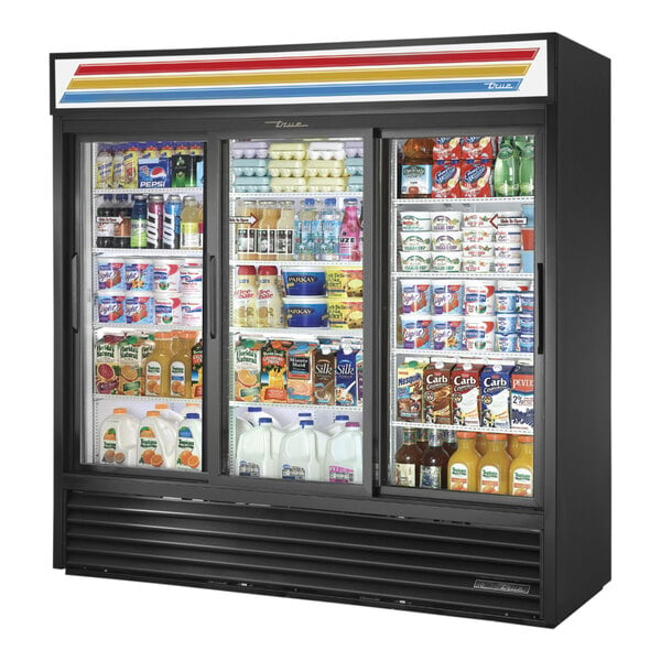 A True black refrigerated glass door merchandiser filled with drinks.
