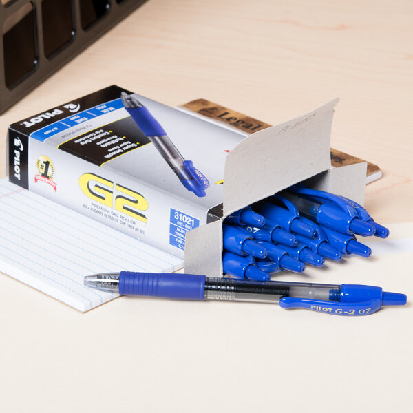 A box of Pilot G2 blue pens on a table.