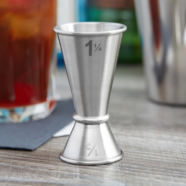 An American Metalcraft stainless steel jigger with a 1.25 oz. cup inside a 0.5 oz. cup.