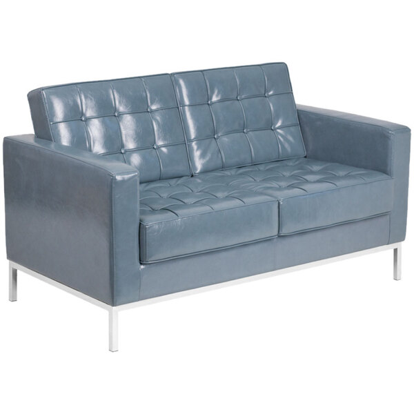 A gray leather loveseat with silver legs.