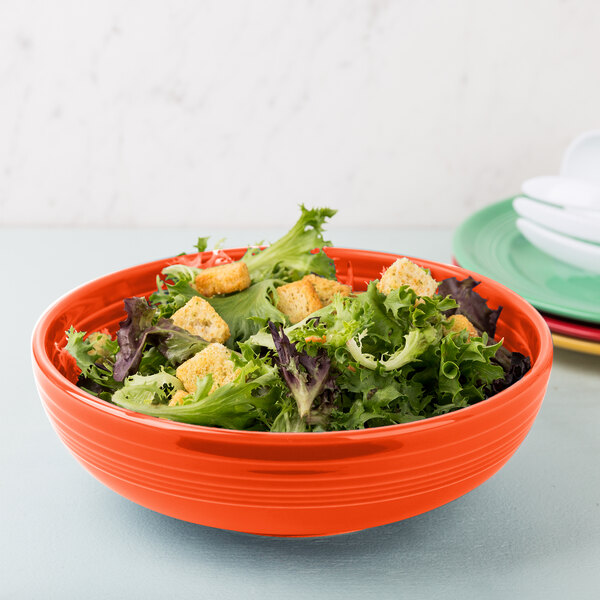 A Fiesta china bistro bowl filled with salad and a fork.
