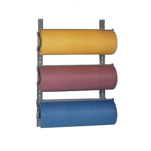 A Bulman paper roll rack holding three rolls of paper on a wall.