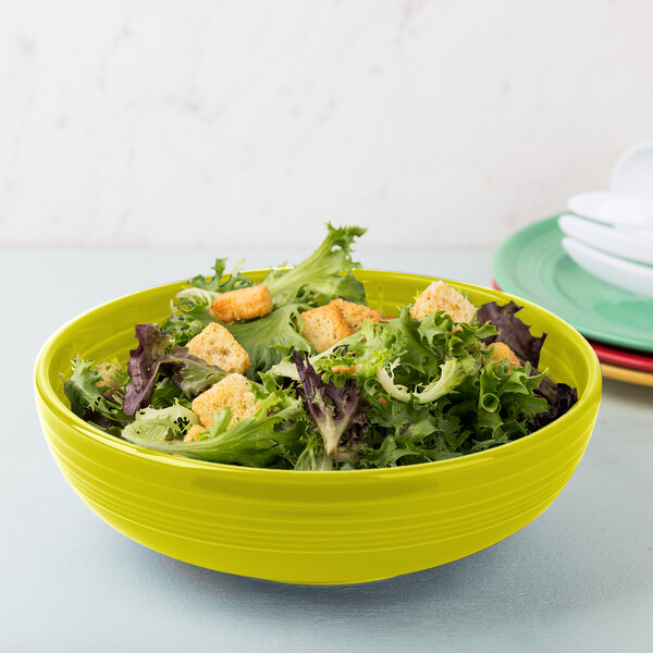 A Fiesta Lemongrass china bistro bowl filled with salad and croutons.