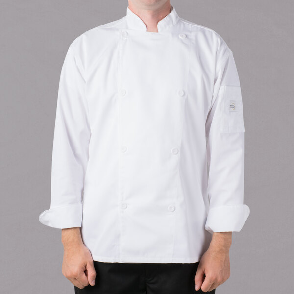 A man wearing a white Mercer Culinary long sleeve chef jacket.