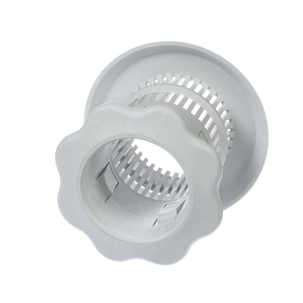 A white plastic Meiko drain plug with a hole in it.