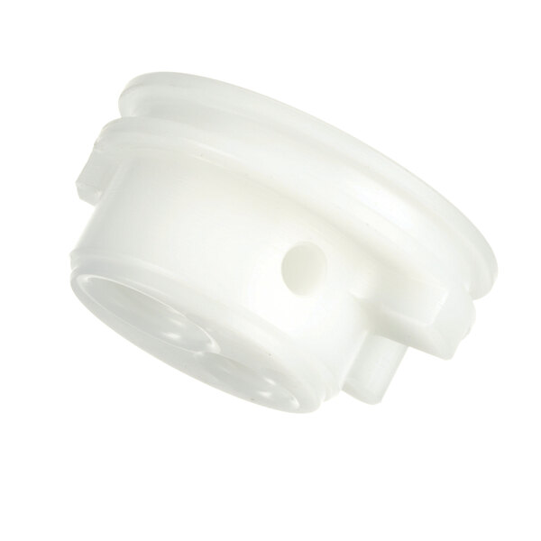 A close-up of a white plastic Taylor valve cap with a hole in it.