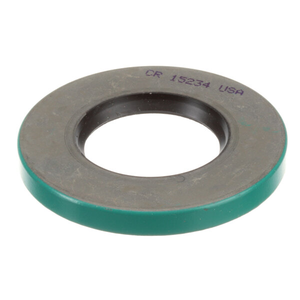 A round metal Blakeslee seal with a green circle.
