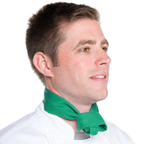 A man wearing a green neckerchief with white polka dots.