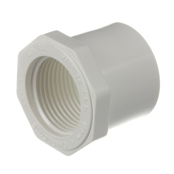 A close-up of a white plastic Hussmann bushing reducer threaded pipe fitting.